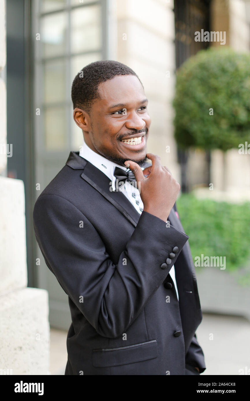Afro american happy good looking male person wearing suit and smiling ...