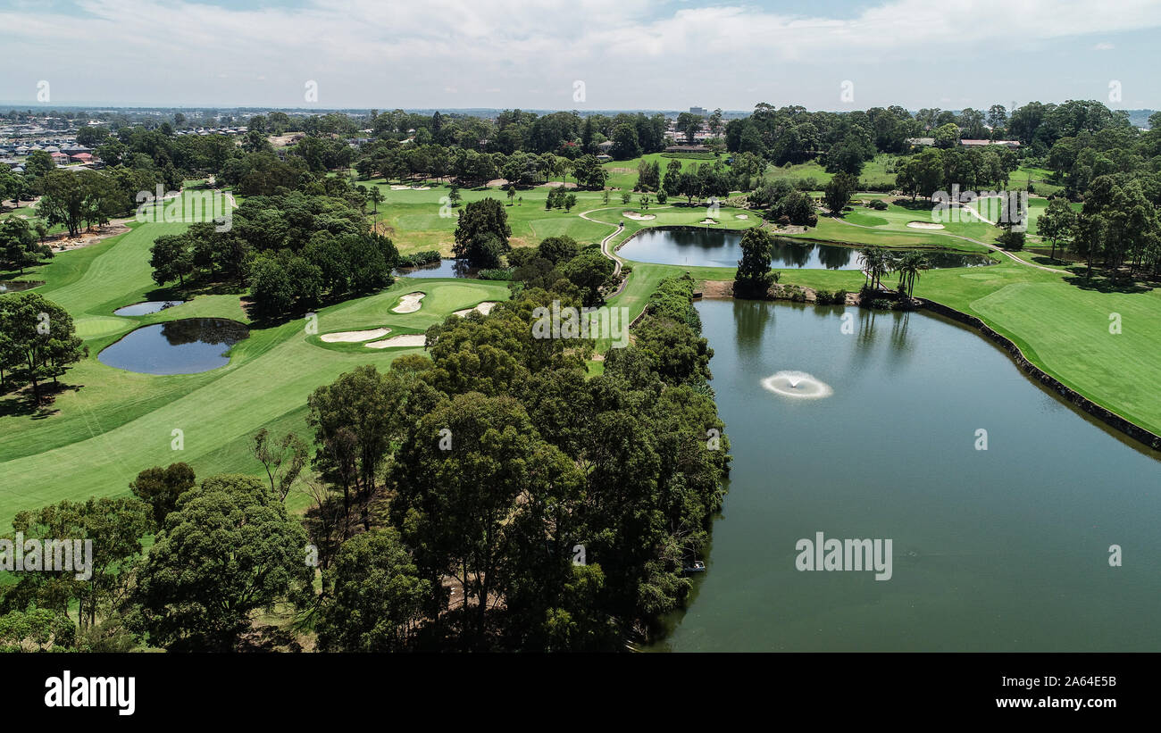 Aerial drone view Golf course fairway, water hazards, fountain, green