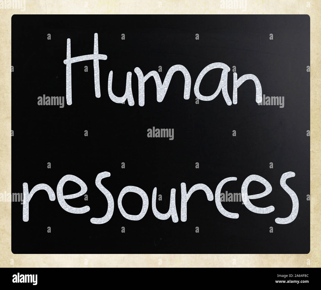 The word 'Human resources' handwritten with white chalk on a blackboard Stock Photo