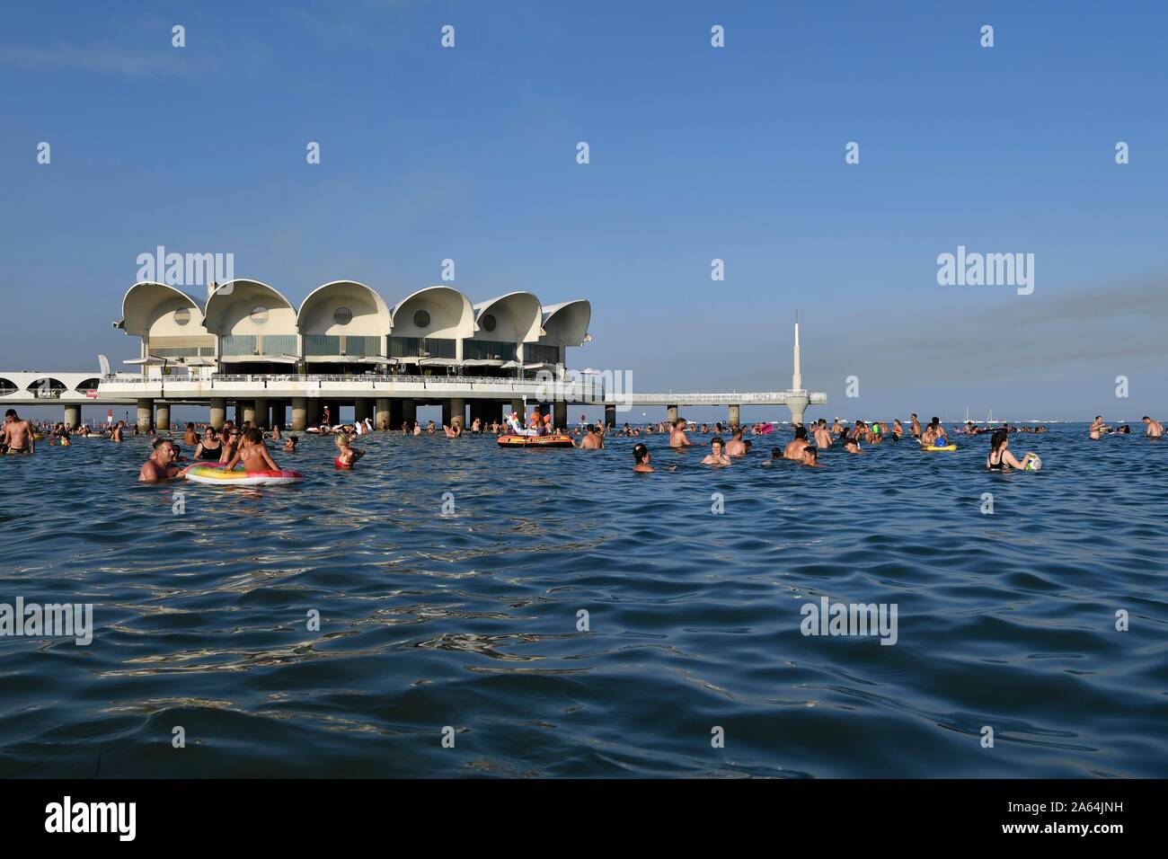 Tourists bathing in the sea, Terrazza a Mare, Lignano Sabbiadoro, Adriatic Sea, Friuli Venezia Giulia, Italy Stock Photo