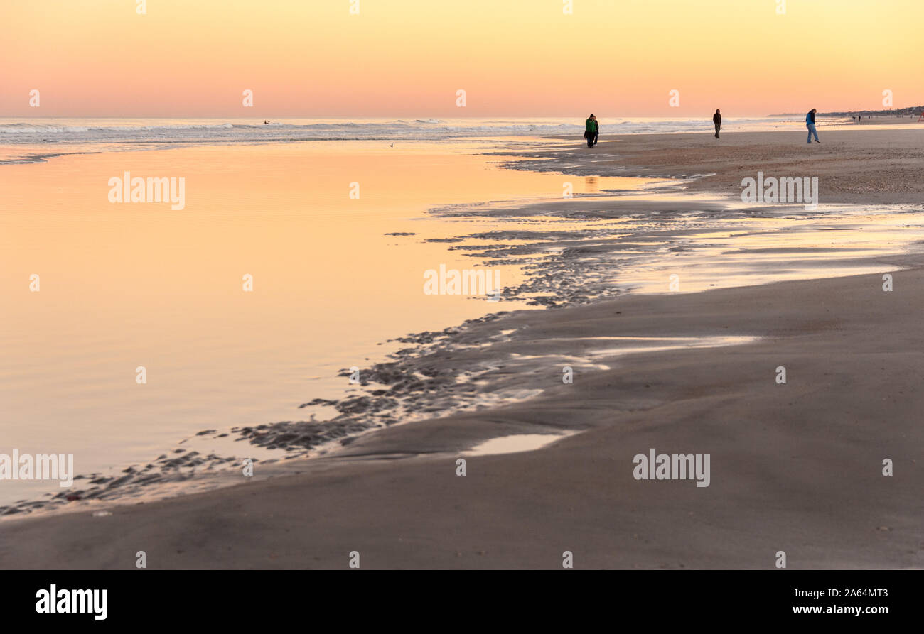 People enjoying a beautiful winter sunset on the beach at Jacksonville Beach in Northeast Florida. (USA) Stock Photo