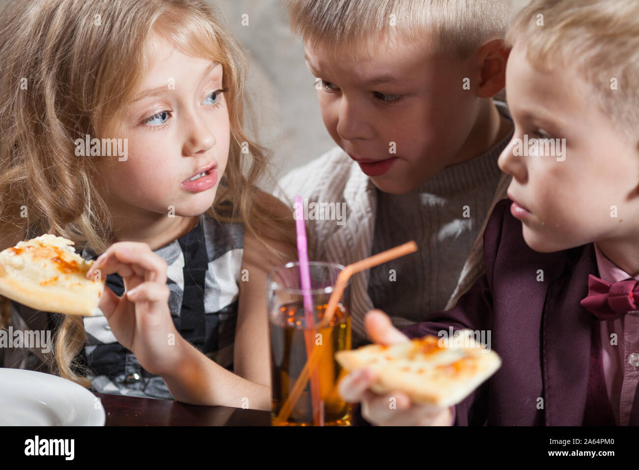 children eat pizza in a restaurant Stock Photo