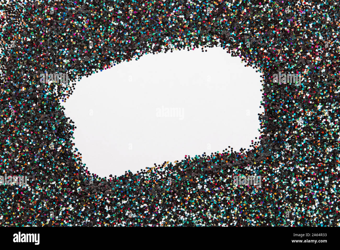 Holographic glitter on black background with empty blank space in the center. Stock Photo