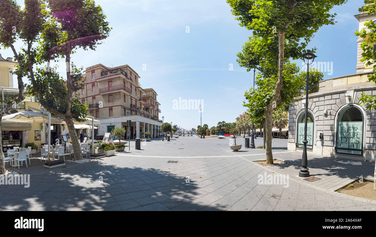 Ostia Lido Rome, Italy - July 19, 2019: Immersive panoramic street view of Anco Marzio square from Stazione Vecchia street ,with palaces facades and Stock Photo
