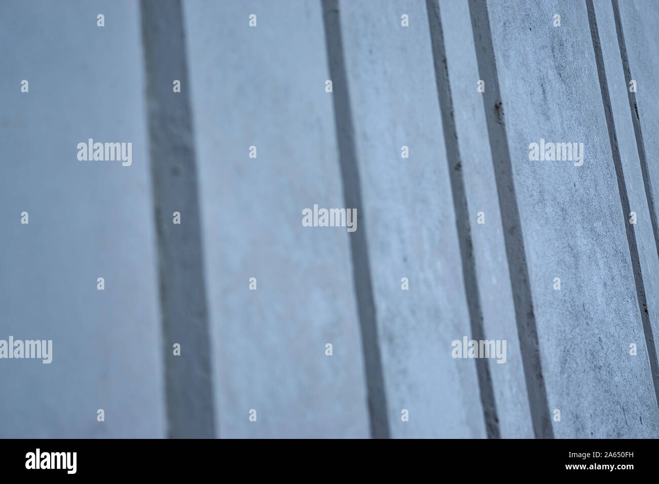 Background image made up of a close up of a modern ribbed concrete wall
