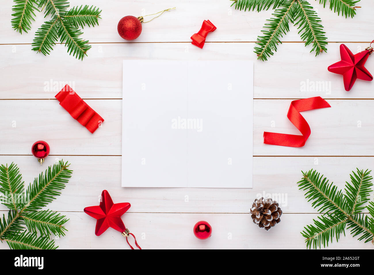 Christmas greeting card mockup. Empty paper for greeting text surrounded with Christmas decorations. Stock Photo