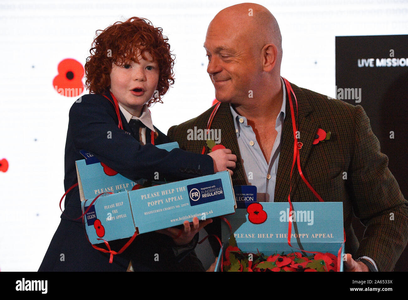 Ross Kemp, with Charlton Fleming, 10, who was 10 months old when his father Royal Marine Michael Taylor was killed in action in Afghanistan, at Kings Cross Station in London for the launch of the Royal British Legion's poppy appeal which this year has a host of celebrities hidden amongst the Legion's 40,000 collectors. Stock Photo