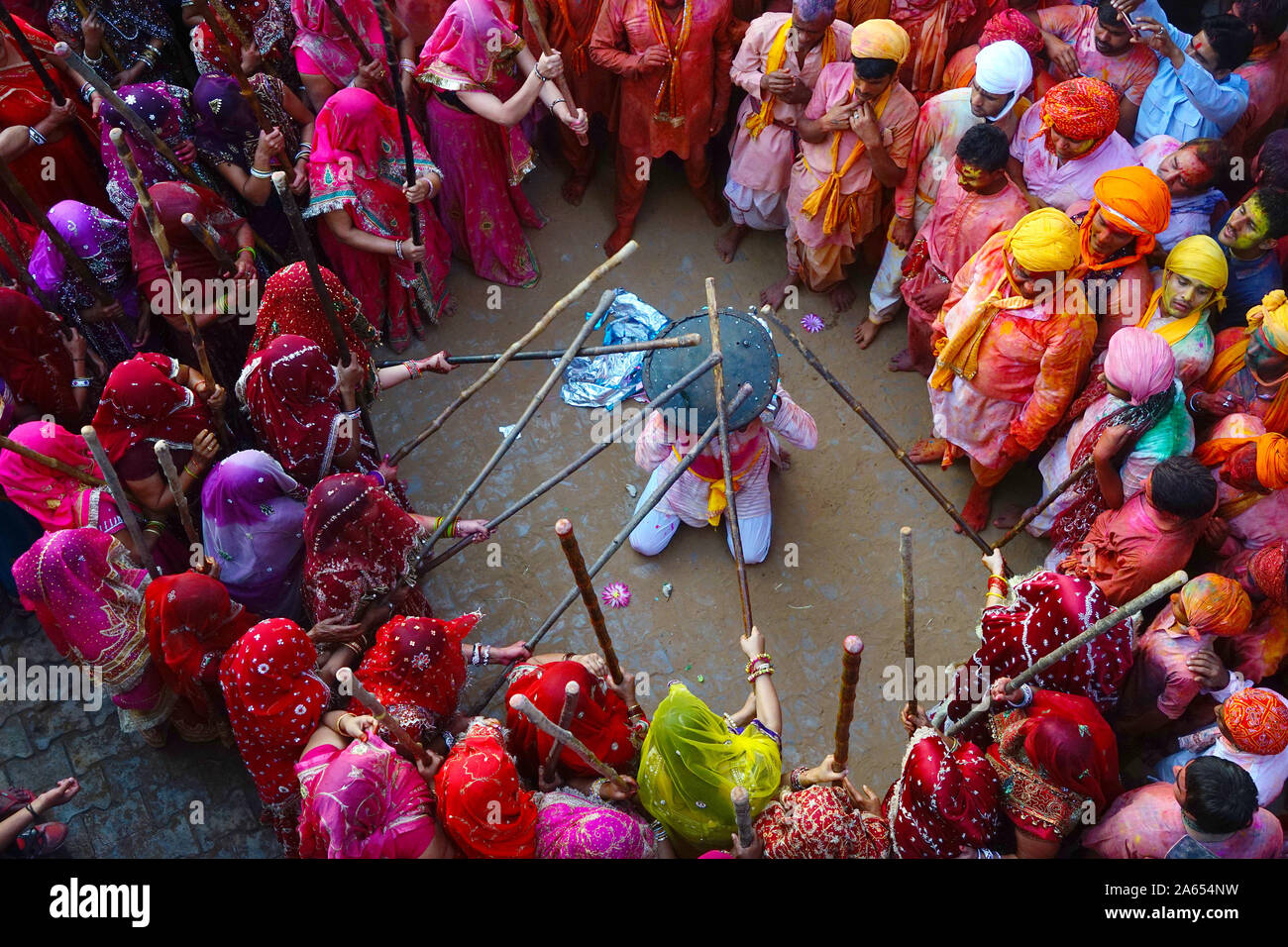 Women beating men with sticks, Lathmar Holi festival, Mathura, Uttar Pradesh, India, Asia Stock Photo