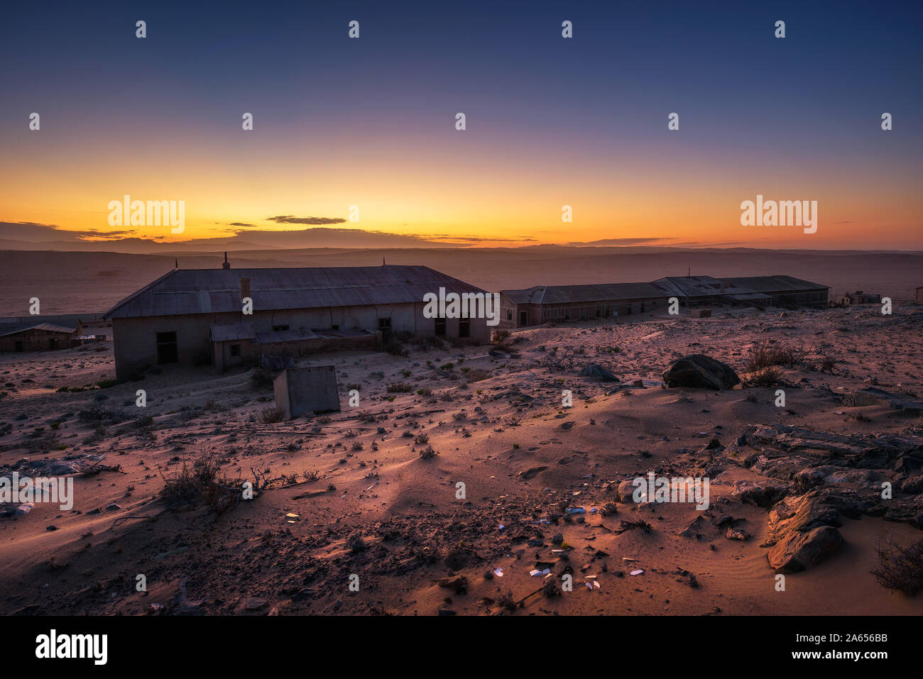 Sunrise above the abandoned houses of Kolmanskop ghost town, Namibia. Stock Photo