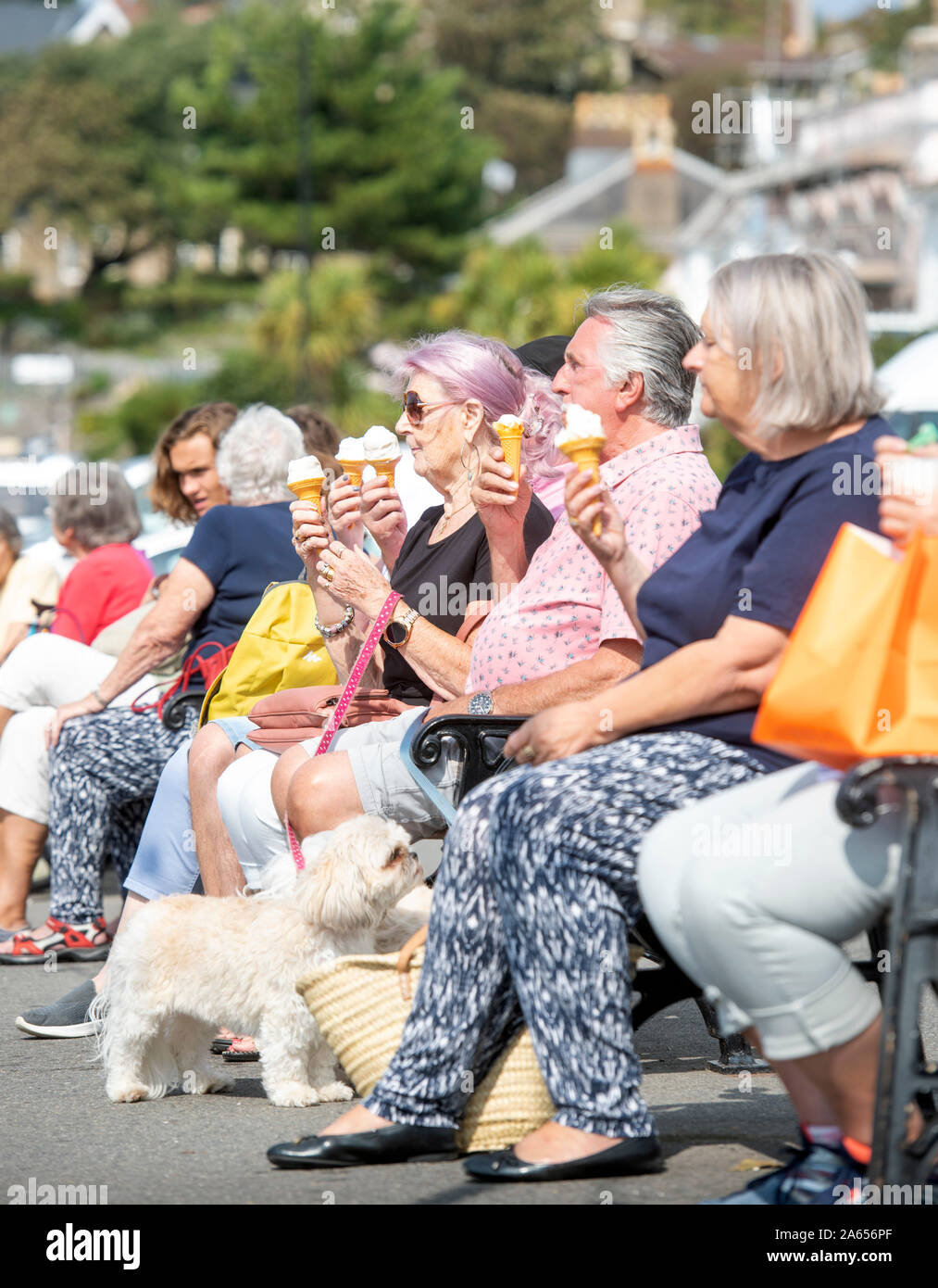 Retired people eating icecreams on the front in the seaside town of Clevedon in North Somerset, UK Stock Photo