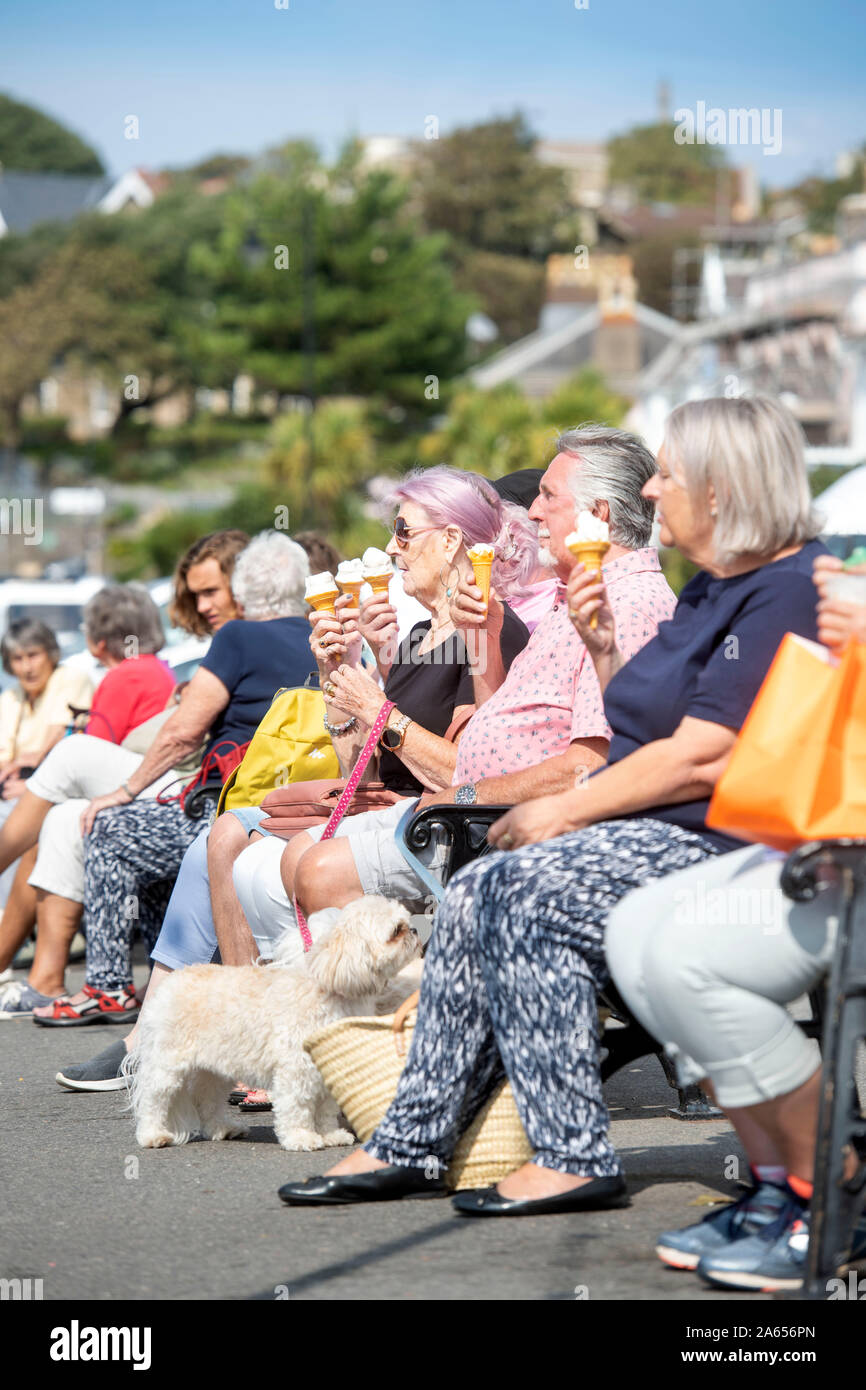 Retired people eating icecreams on the front in the seaside town of Clevedon in North Somerset, UK Stock Photo