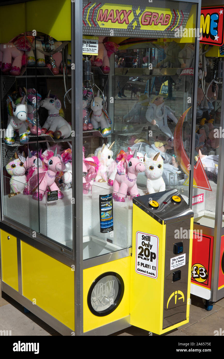 A Game to Win Stuffed Unicorn Dolls or Animals at an Amusement Arcade in Scarborough North Yorkshire England United Kingdom UK Stock Photo