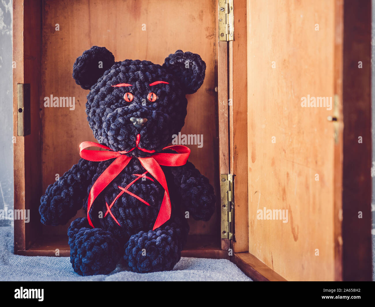 Teddy bear, sitting in a wooden box Stock Photo