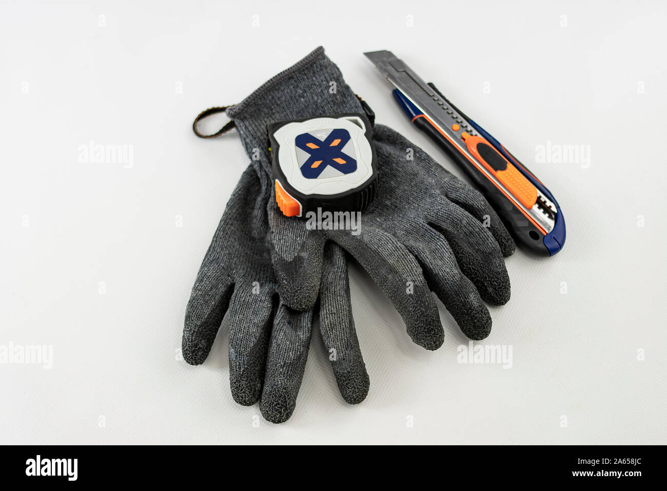 textile gloves with rubber or latex protection with a flexible meter and a cutter  Stock Photo - Alamy