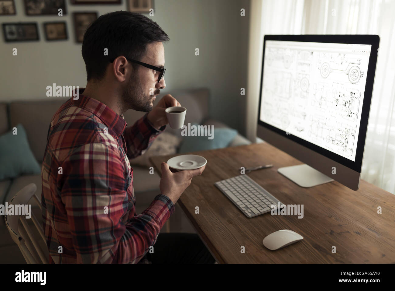 Young handsome designer working on project on computer Stock Photo