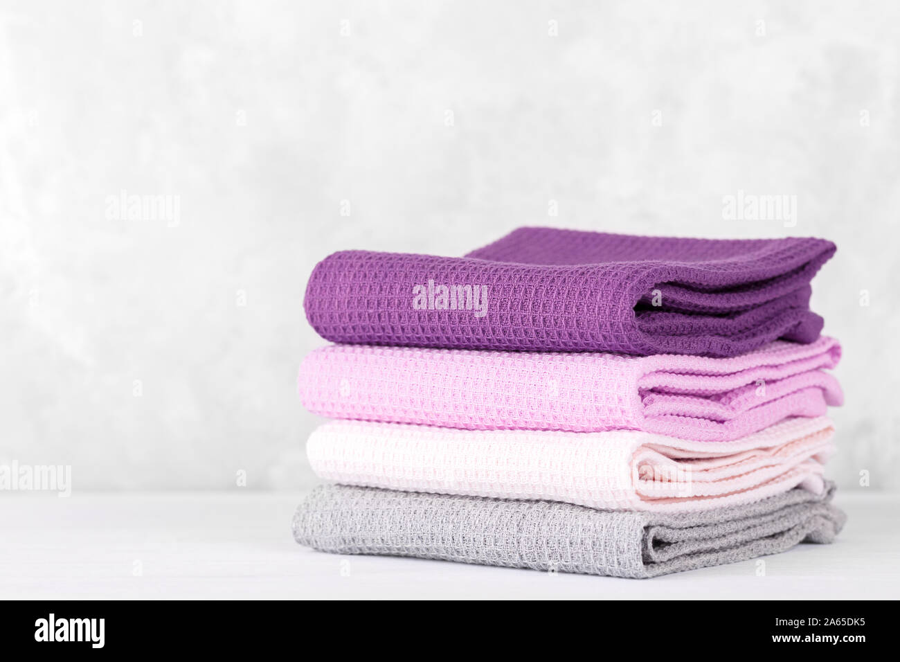 Stack of colorful cotton kitchen towels copy space, pastel lilac colors  Stock Photo - Alamy