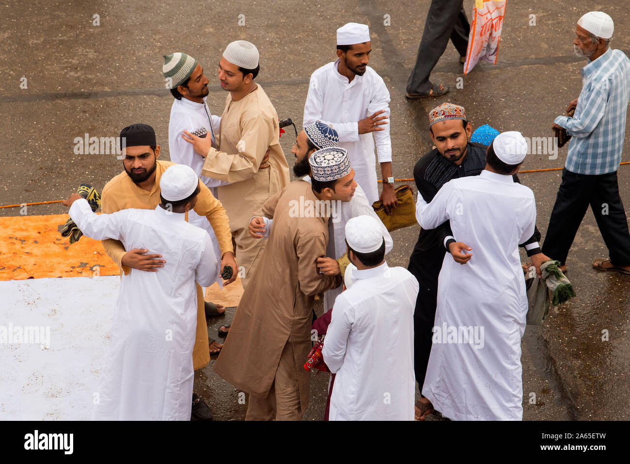 Muslims embracing greetings, Eid Al Fitr festival, Mumbai, Maharashtra, India, Asia Stock Photo