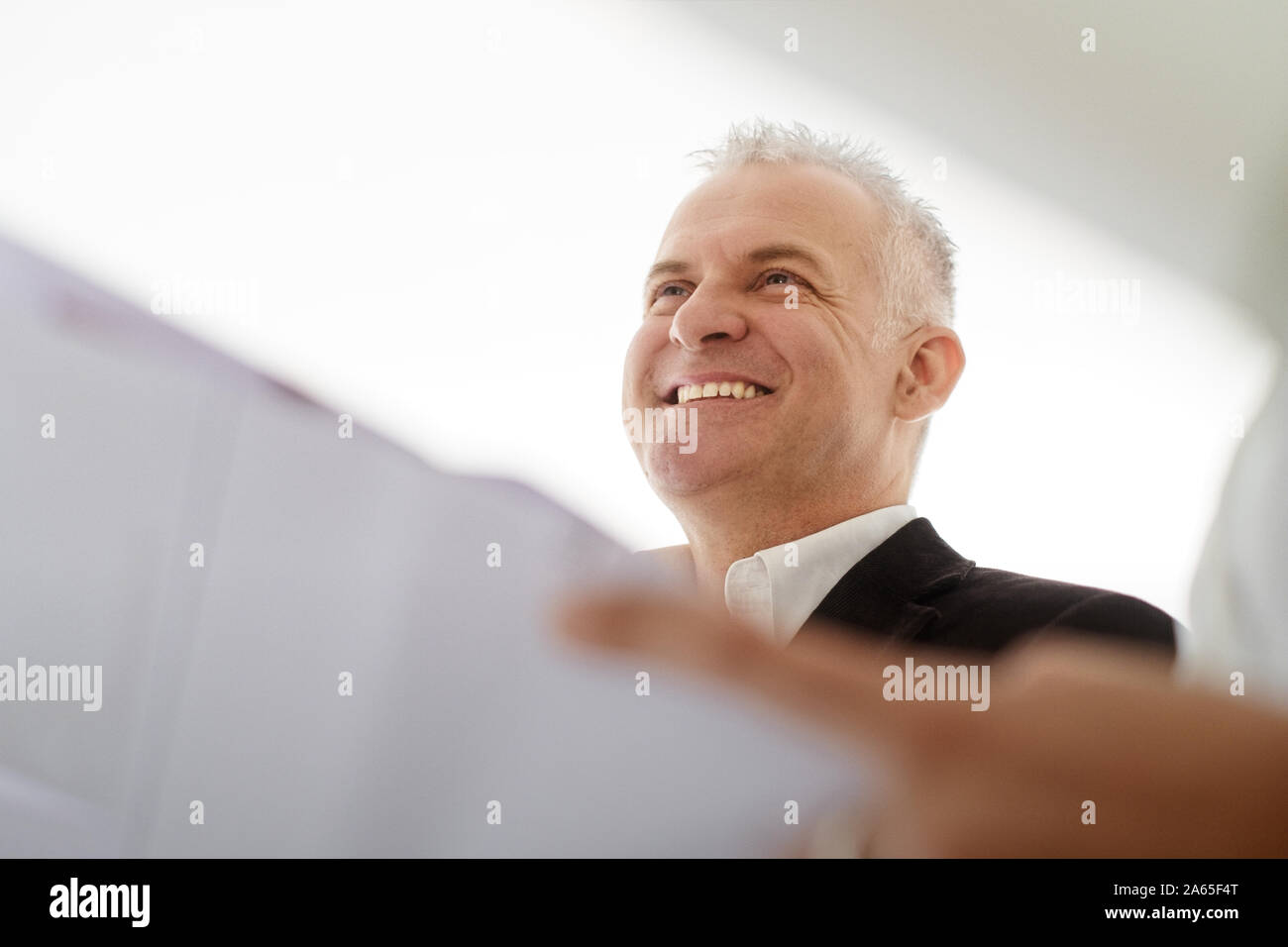 Teamwork With Architect Looking At Plans During Meeting Stock Photo