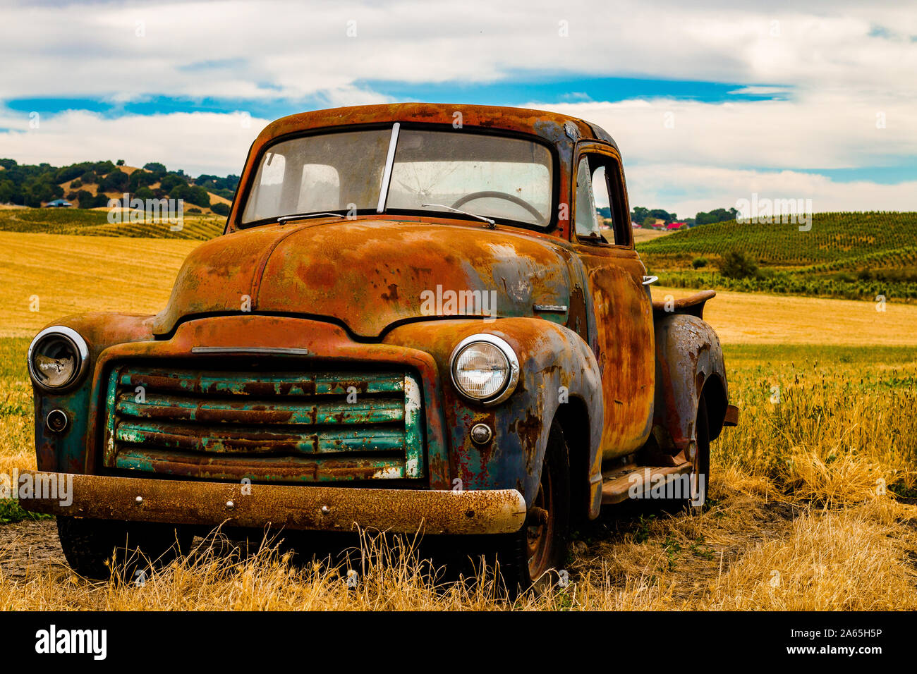 Vintage truck rusted in field Stock Photo