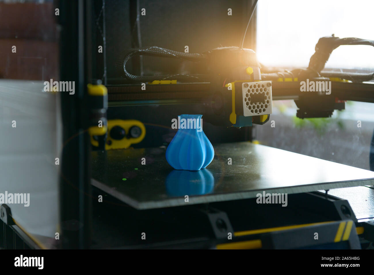 Modern 3d printer with printed three dimentional model of vase. Stock Photo