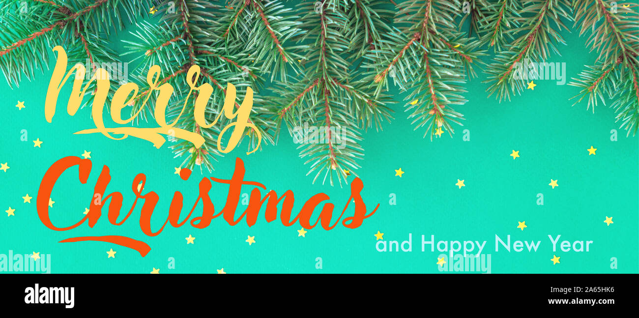 Seasonal banner with border of green fir branches, gold confetti stars ...