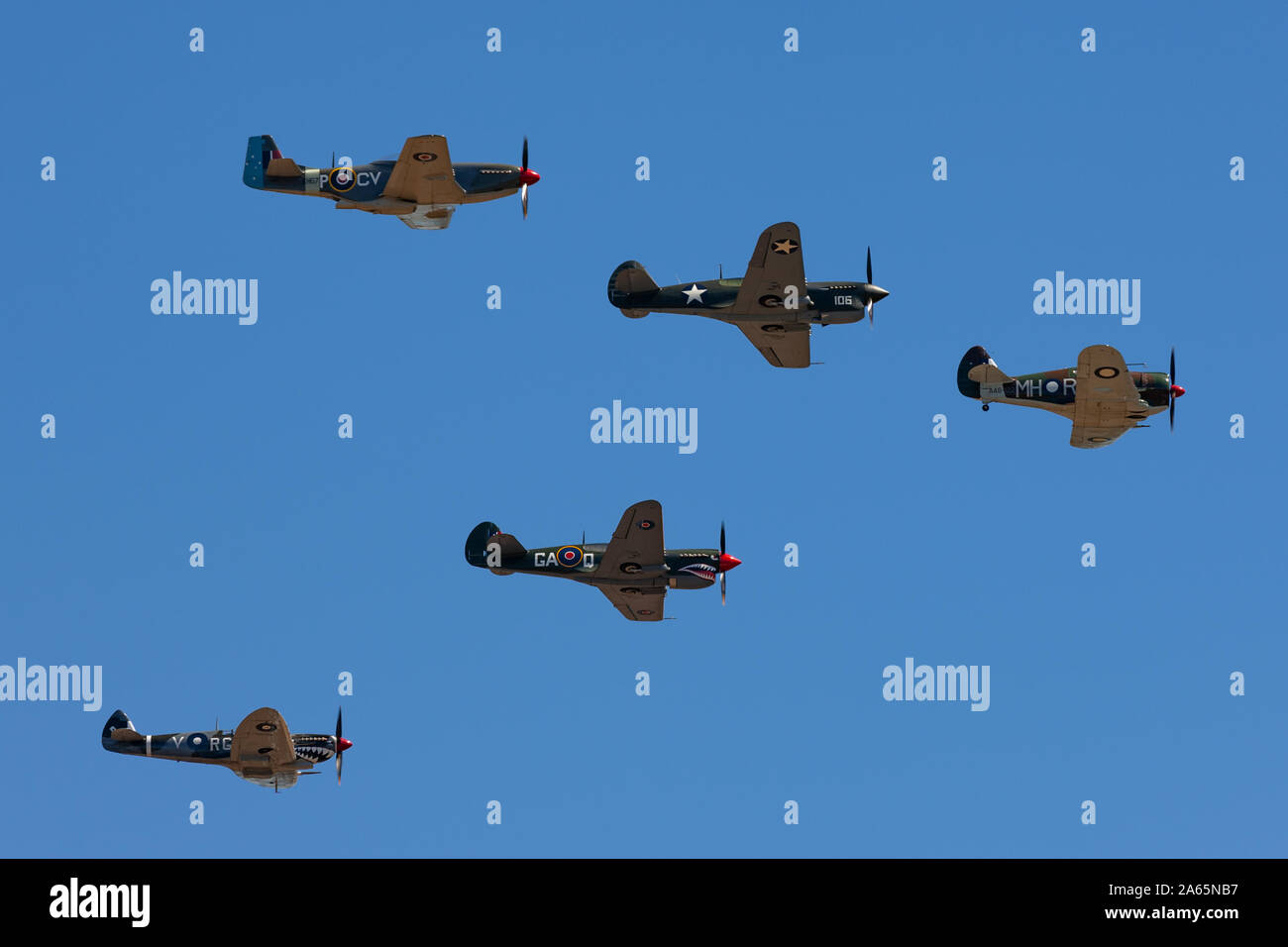 Formation of World War II fighter aircraft comprising a CAC Boomerang, two P-40 Kittyhawks a P-51 Mustang and a Sup Stock Photo