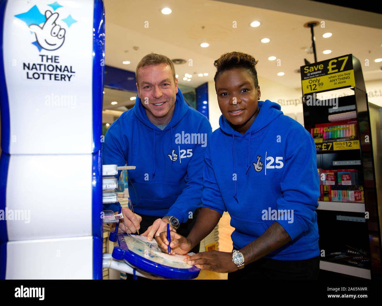 Sir Chris Hoy (left) and Nicola Adams filling in their National Lottery's numbers during a photocall at Westfield Stratford City, London. Stock Photo