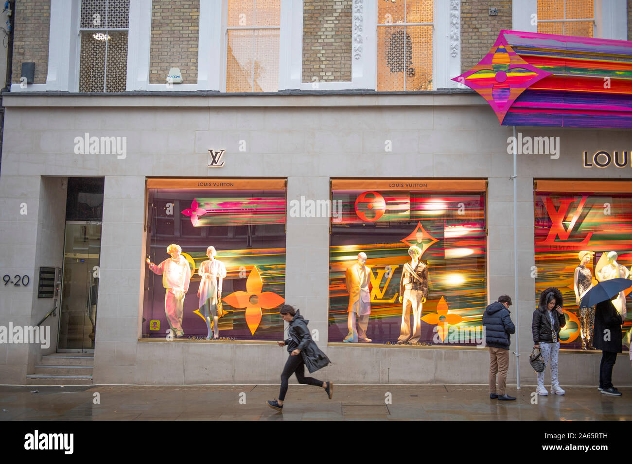 New Bond Street, London, UK. 24th Oct 2019. The refurbished Louis Vuitton  store re opens with a huge and colourful explosion of stars installation on  its corner outside wall. Credit: Guy Bell/Alamy