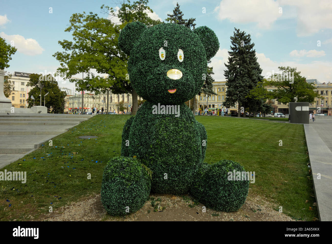 Kharkiv, Ukraine, August 2019 Big teddy bear topiary figure in city park. Outdoor fun decoration from green plant and bushes. Kids entertainment place Stock Photo