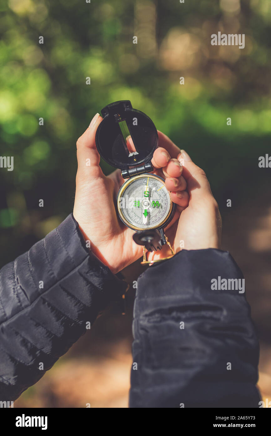 Female hiker looking compass hi-res stock photography and images - Alamy