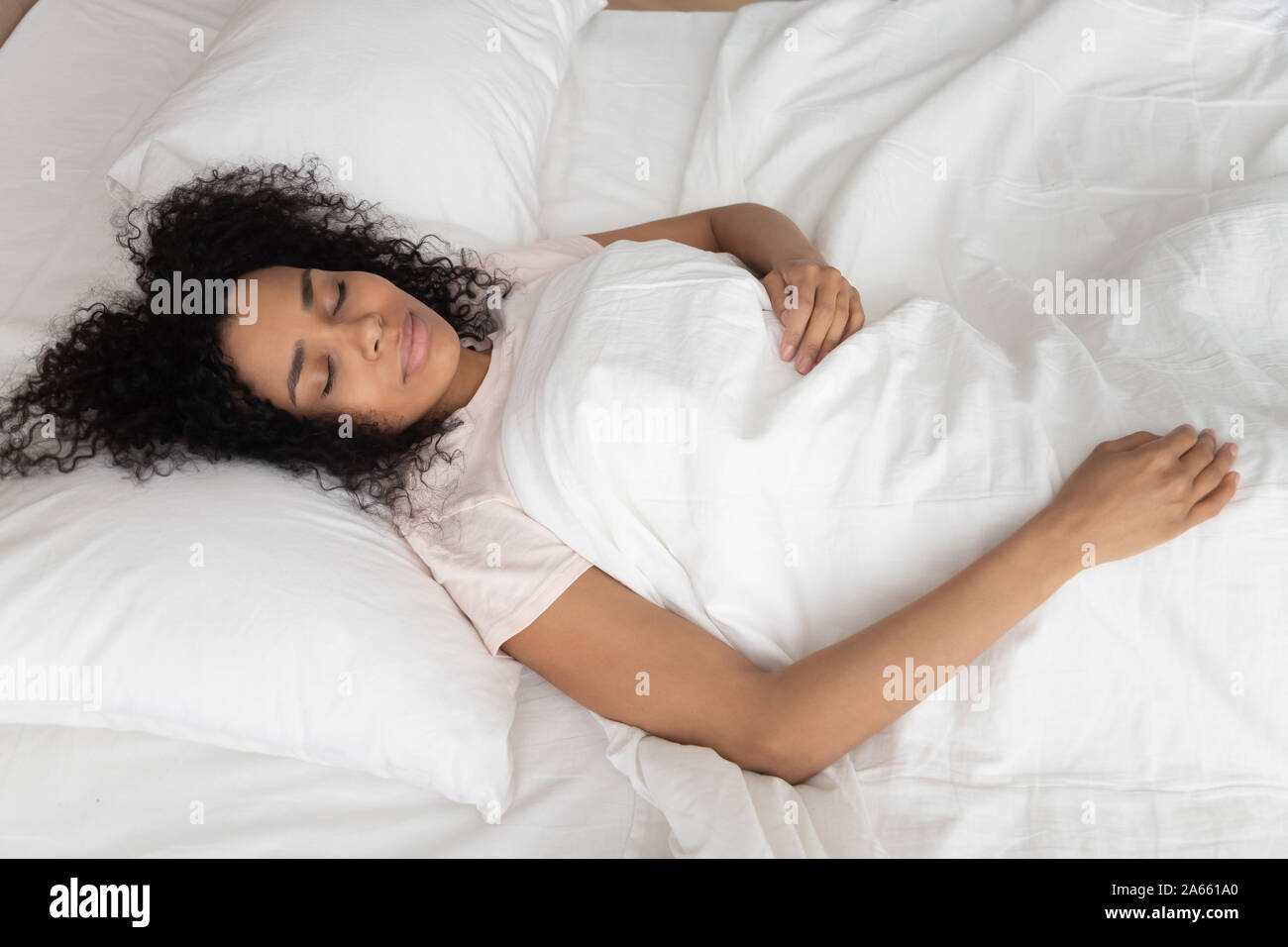 Calm tired black girl sleeping in white bed Stock Photo - Alamy