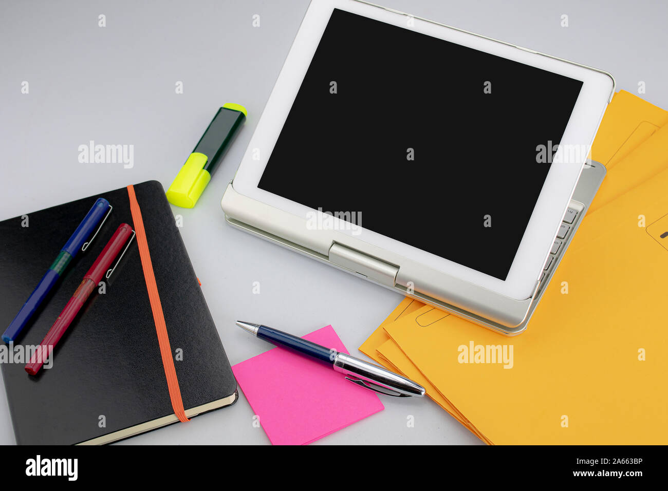 Office supplies consisting of tablet with keyboard, fluorescent marker ...