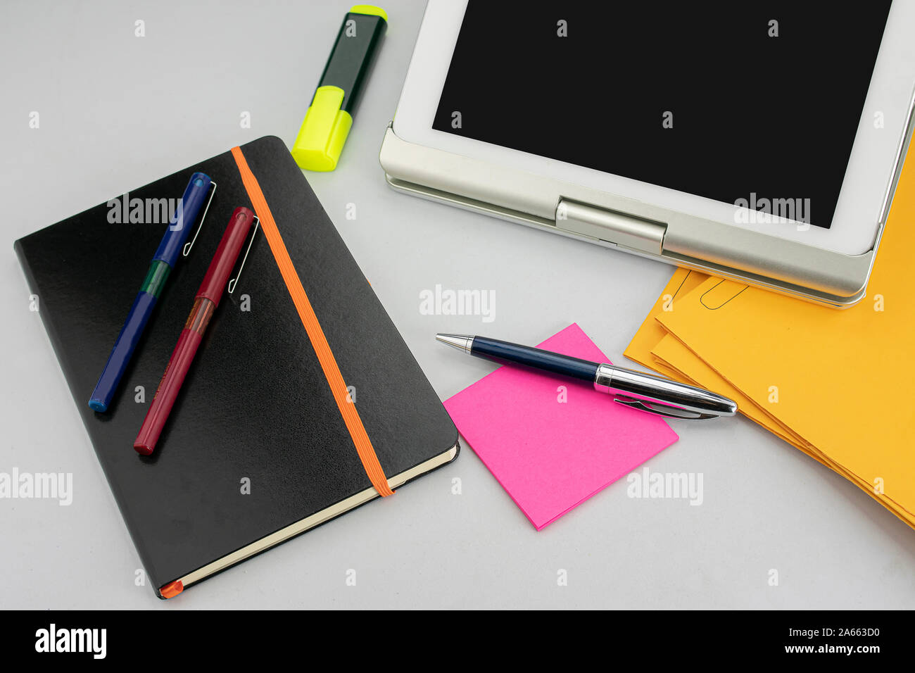Office supplies consisting of tablet with keyboard, fluorescent marker ...
