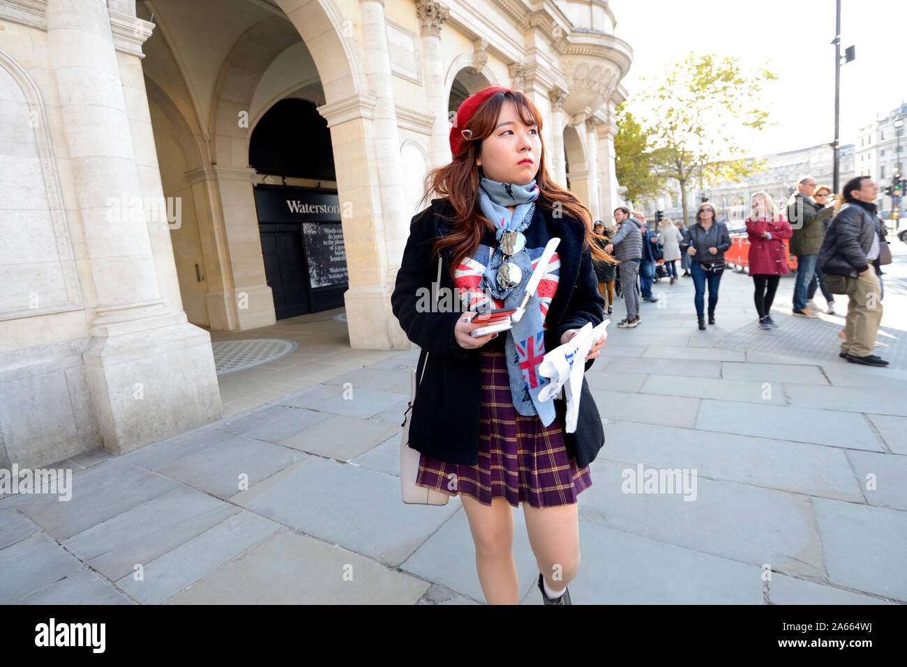 London, England, UK. Young female Japanese tourist in Trafalgar Square Stock Photo