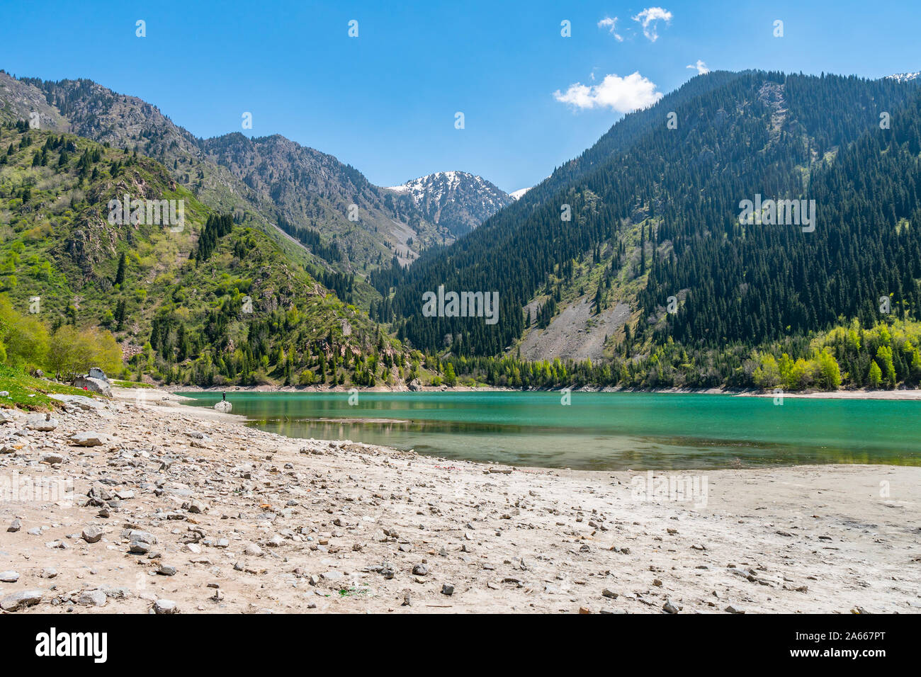 Esik Lake Issyk Picturesque Breathtaking View with Snow Capped Mountains on a Sunny Blue Sky Day Stock Photo