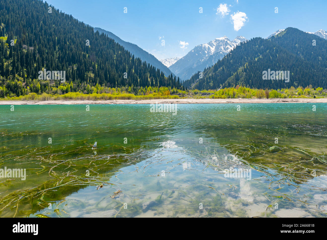 Esik Lake Issyk Picturesque Breathtaking View with Snow Capped Mountains on a Sunny Blue Sky Day Stock Photo
