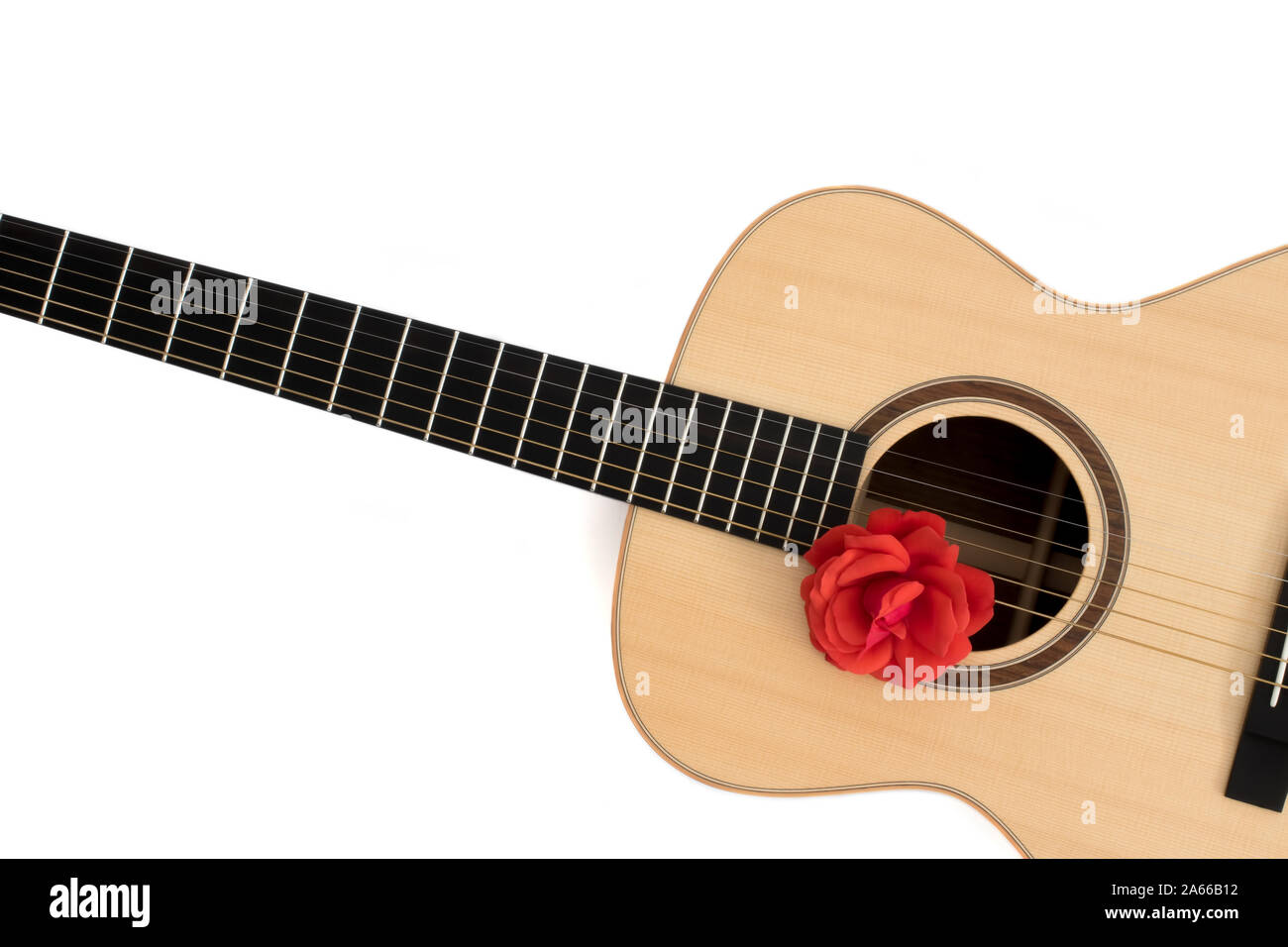 Love song. Acoustic guitar with red rose. Romantic music concept image. Folk guitar with flower on white background copy-space. Romance and serenade. Stock Photo