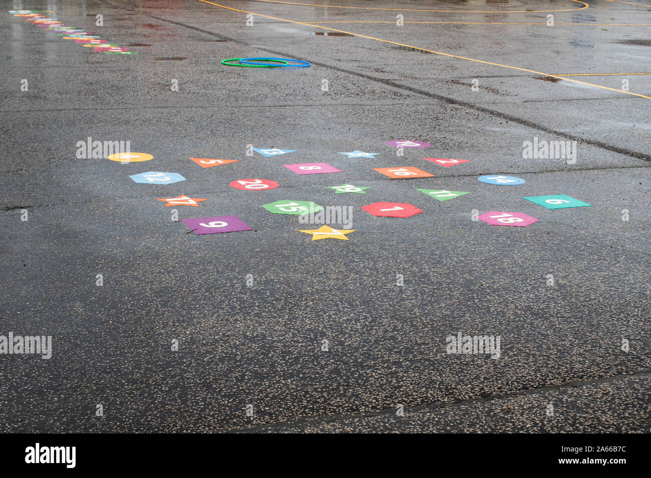 Wet playtime. Rainy day school playground games. Schoolyard abandoned after rain. Outdoor play area during indoor break. Stock Photo