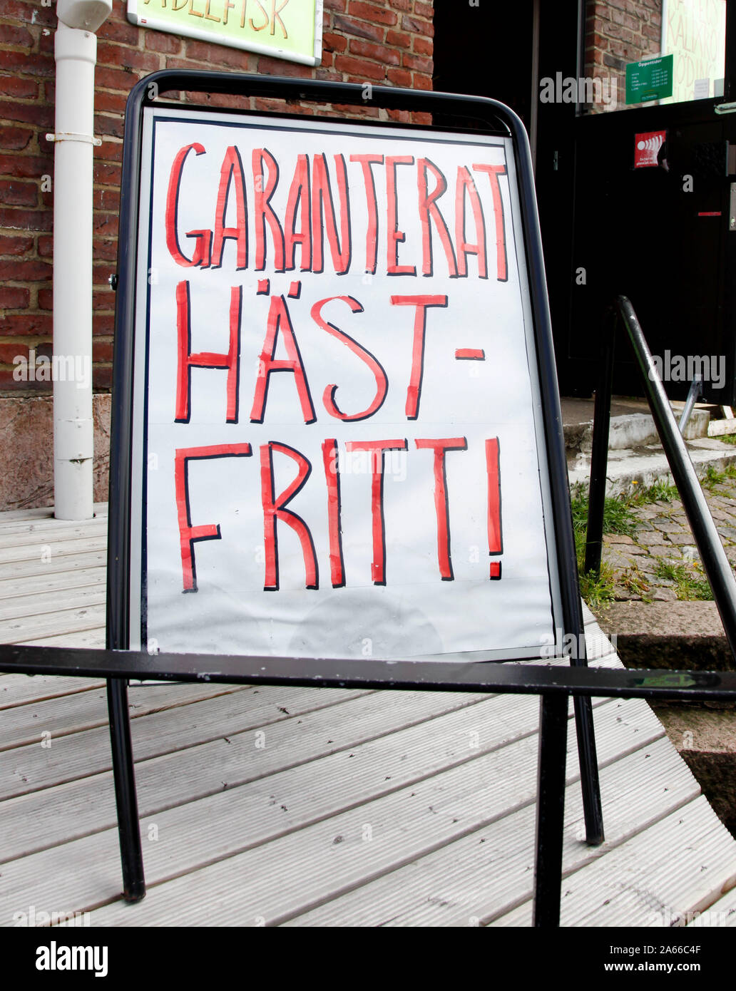Sign outside a grocery store announcing 'Guaranteed horse-free'. Photo Jeppe Gustafsson Stock Photo