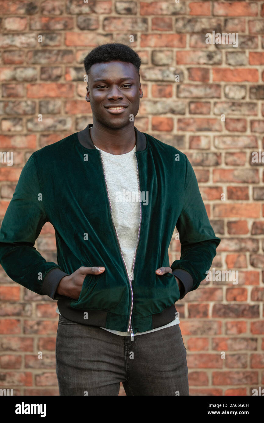 Man in front of brick wall hi-res stock photography and images - Alamy
