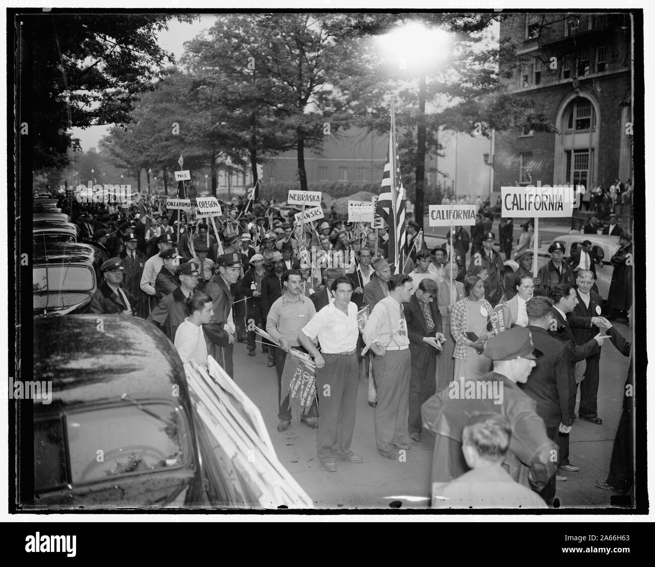 WPA workers stage march in fight for reinstatement. Washington, D.C. Aug. 24. Police were as numerous as the marchers today when over 2000 dismissed W.P.A. workers, assembled here by the Workers Alliance of America, staged a march to the White House, Capitol, and Harry Hopkins' office in their fight for reinstatement to their old jobs. 8/24/37 Stock Photo