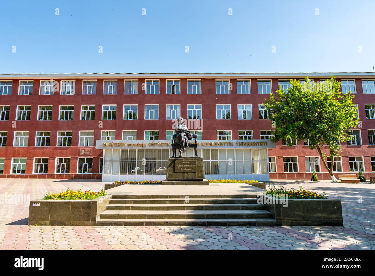 Shymkent South Kazakhstan State University Auezov View with Statue of Sultan Suleymenov on a Sunny Blue Sky Day Stock Photo