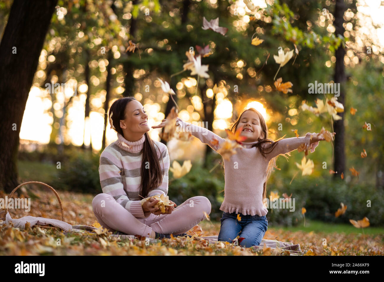 Mother and daughter enjoying autumn in park Stock Photo - Alamy
