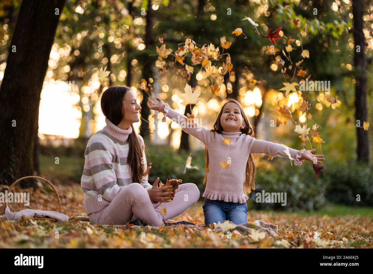 Mother and daughter enjoying autumn in park Stock Photo - Alamy