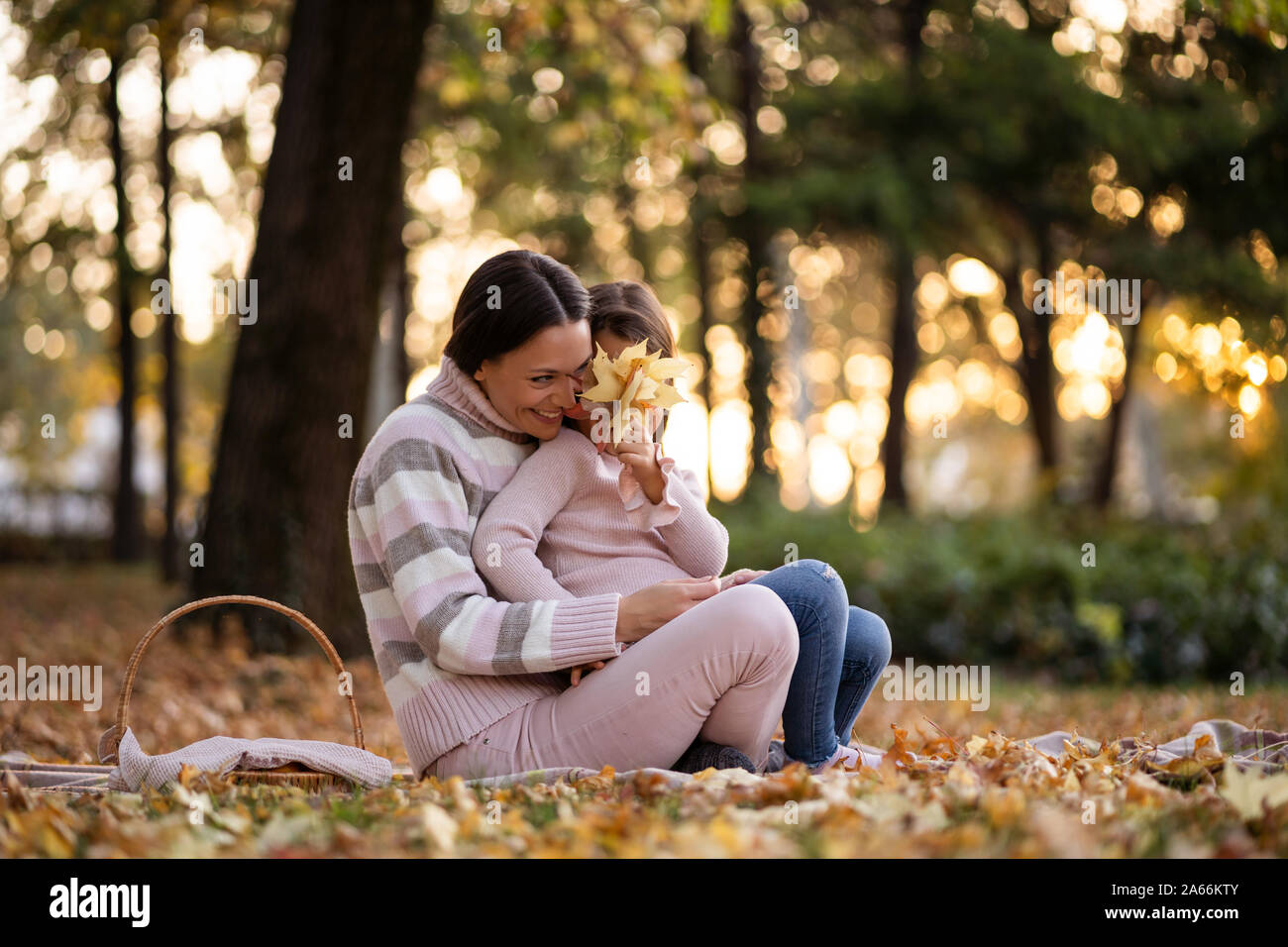 Mother and daughter enjoying autumn in park Stock Photo - Alamy