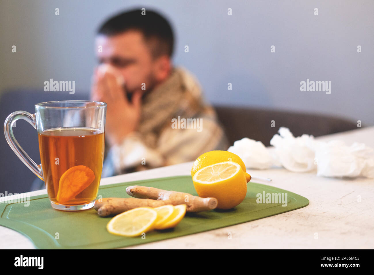 The concept of the disease, winter time. Black tea, lemon and ginger on ...