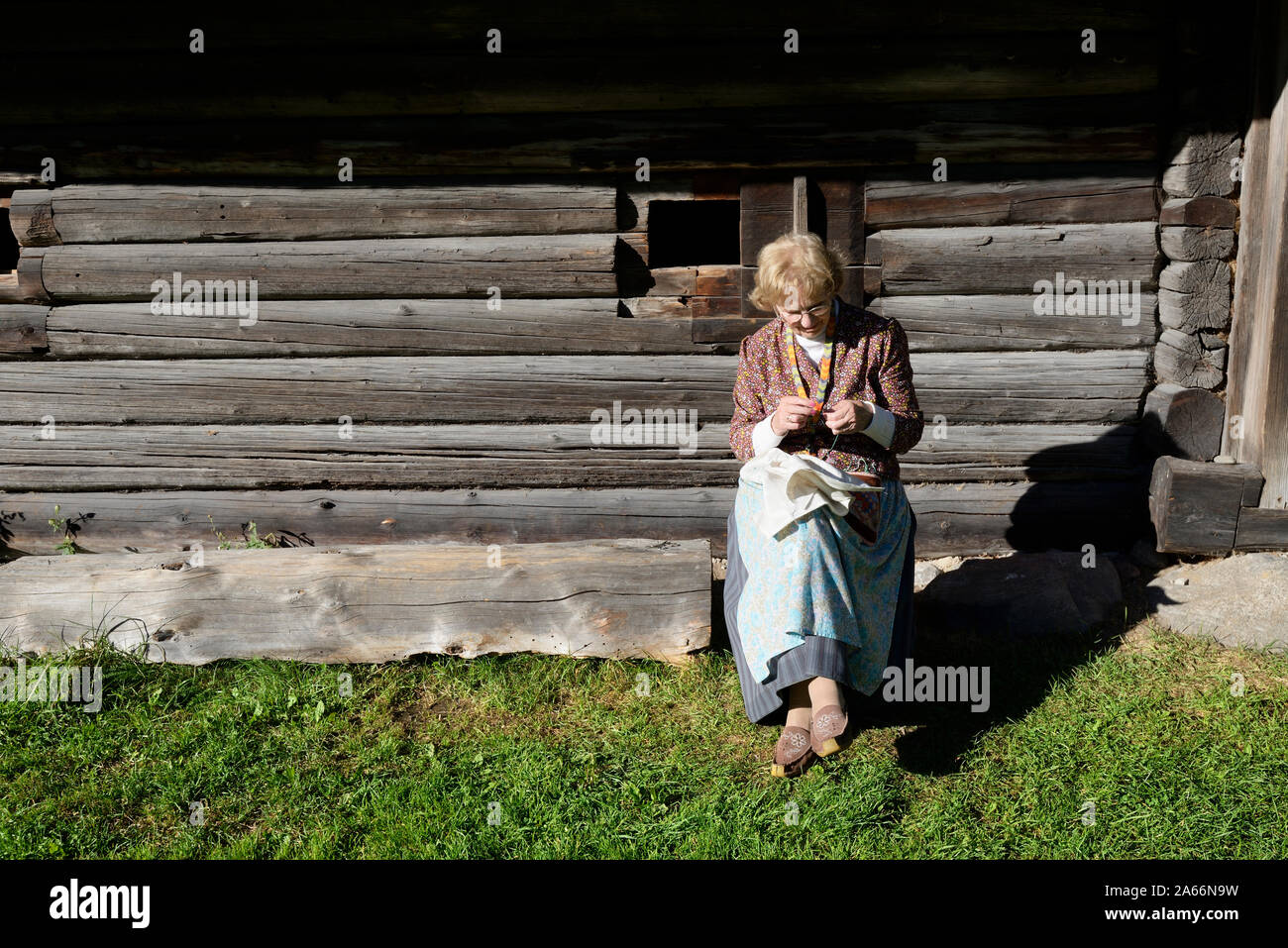 Woman making embroidery in a farmhouse. Estonian Open Air Museum, Rocca al Mare. Tallinn, Estonia Stock Photo