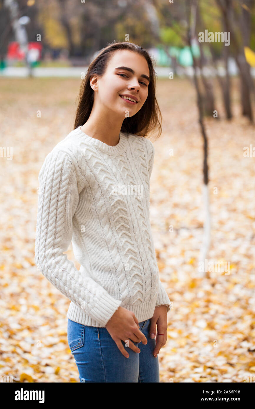 Close up portrait of a young beautiful girl in a white woolen sweater in autumn park Stock Photo Alamy