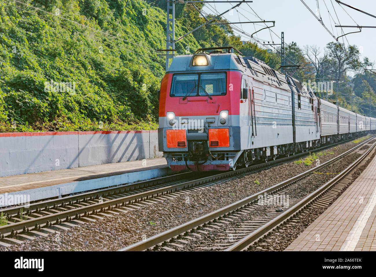 Passenger train from Adler moves by Black sea coast. Sochi. Russia. Stock Photo