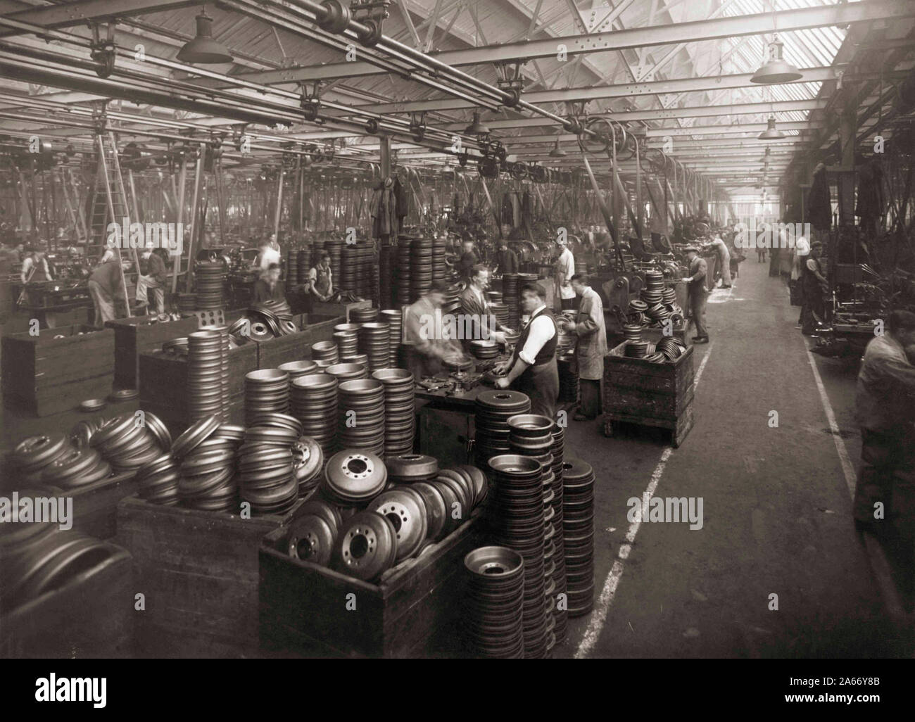 Interior Wolseley Motors near Birmingham in the 1930’s.  Workers  preparing hubcaps. Stock Photo